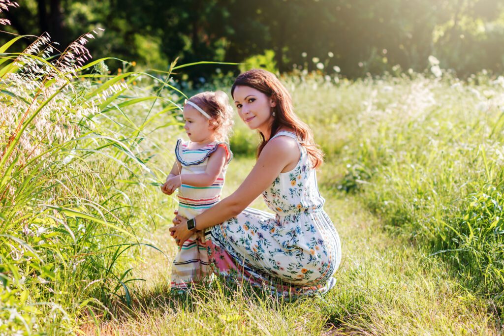mother daughter in grass field